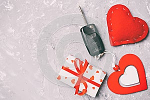 Top view of a present for Valentine\'s Day on wooden background. Car key, gift box and heart with copy space. Surprise concept for