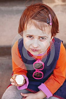 Top view of pretty little child girl eating ice cream outdoors food, dessert, childhood, satisfaction, carelessness concept