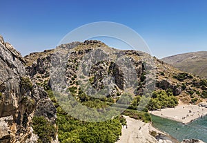 Top view of Preveli beach and river Megalo Potamos Megalopotamo in the place where it flows into the Libyan sea, Crete