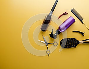 Top view of professional hair dresser tools on yellow