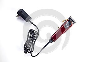Top view of professional single red corded electric hairclipper on white background