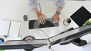 Top view programmer working on developer space with computer and device screen.