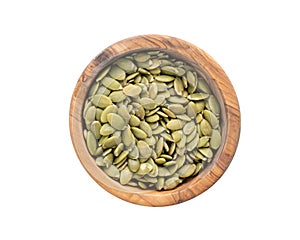 Top view pumpkin seeds in wood bowl isolated on white background