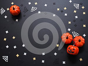 Top view of pumpkin, spiders and web shape on black grunge texture for halloween background