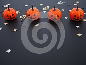 Top view of pumpkin, spiders and web shape on black grunge texture for halloween background