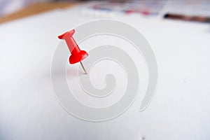 Top view of push pins on white paper background