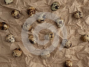 Top view of quail eggs on crumpled craft paper. geometric natural background.