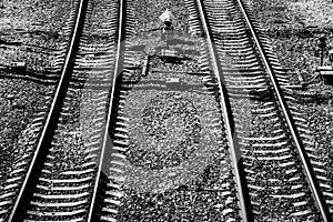 Top view of a railway track on a sunny day. Steel rails. Crushed stone. Concrete sleepers. Traffic light. Automation systems