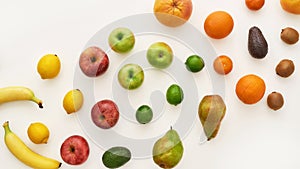 Top view of rainbow composition of various colorful fresh fruits isolated over white background