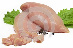 Top view of raw chicken fillet chunks on white