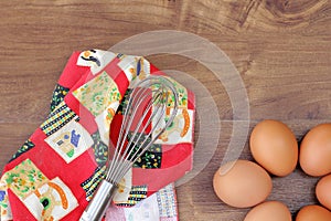 Top view of raw eggs with egg beater.