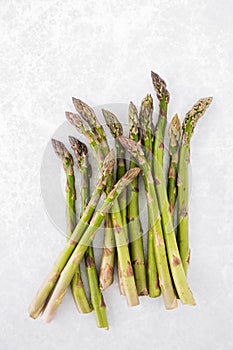 Top View of Raw and Fresh Green Asparagus Stems on Gray Background