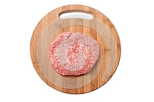 Top view of raw hamburger on wooden board prepared for roasting