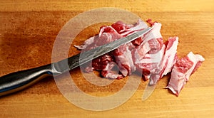 Top view raw pork chop steak and garlic, pepper on wooden background.