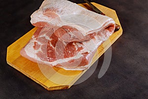 Top view raw pork chop on wooden background with free text space