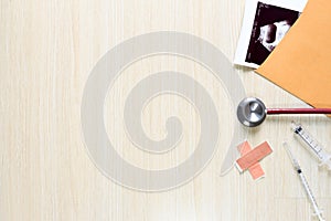 Top view of x-ray paper in envelope with stethoscopes, plaster a