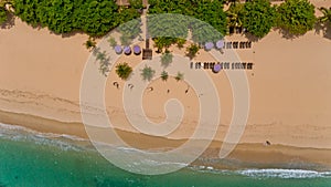 Top view on recreation area with umbrellas on the Sanur beach.