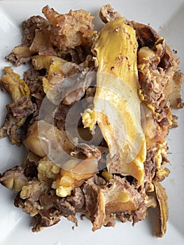 Top view on a rectangular plate full of cooked beef bones and tendons