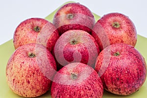 Top view of red apples of pero bravo esmolfe species washed with fresh water on a green plate photo