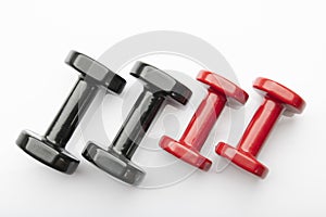 Top View of Red and Black Colored Dumbbells Isolated on White Background