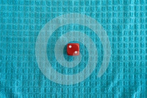 Top view of red dice on a blue fabric patterned surface