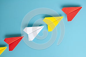 Top view of red paper airplane origami leading other paper airplanes. With copy space for text.