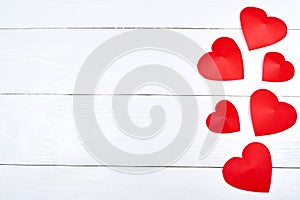 Top view of red paper hearts border on white wooden background, copy space for text. Greeting card mockup for Saint Valentines Day