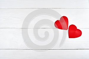 Top view of red paper hearts border on white wooden background, copy space for text. Greeting card mockup for Valentines Day