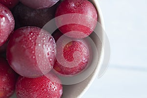 Top view of red plums with water drops