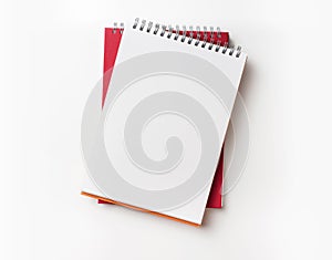 Top view of red spiral notebook and pencil