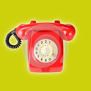 Top view Red vintage phone on a yellow background