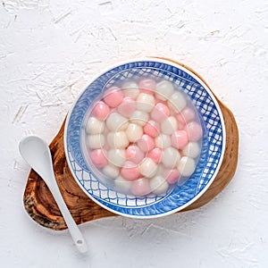 Top view of red and white tangyuan in blue bowl on white background for Winter solstice photo