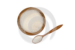 Top view of refined granulated sugar in wooden plate and in wooden spoon on white background