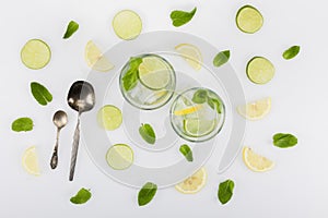 Top view of refreshing citrus beverages and spoons