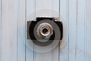 Top view of retro style camera on blue wooden table