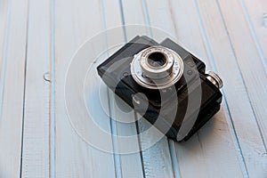 Top view of retro style camera on blue wooden table