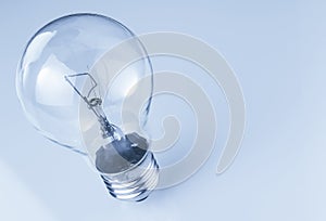 Top of view of retro vintage light bulb with on blue tint background