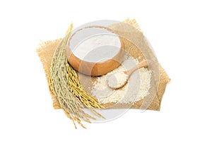 Top view of rice flour in a wooden bowl with rice and rice ears isolated on white background