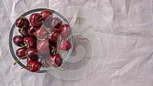 Top view on ripe juicy cherries in a glass bowl