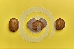 Top view of ripe kiwis isolated on a yellow background