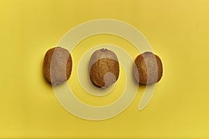 Top view of ripe kiwis isolated on a yellow background