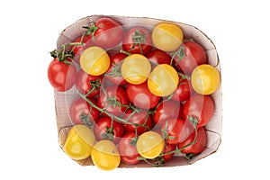 Top view of ripe red and yellow tomatoes in a cardboard box on a white background