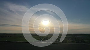 Top view of the road with cars and fields around the road at sunset.Fields and trees near the highway with moving cars