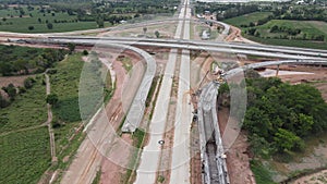 Top view of  road under construction with heavy machinery and workers.