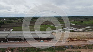 Top view of  road under construction with heavy machinery and workers.