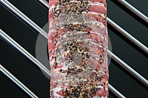 Top view from a roast porkwith pepper on a cooking grate