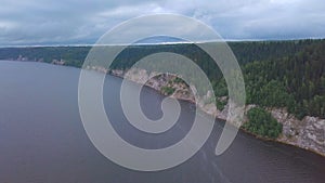 Top view of rocky shore of lake with forest. Clip. Panorama of lake with rocky shore on background of green forest and