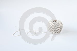 Top view roll of cotton natrue string twine on white background and space for text. Crafting supply, decoration book, or tie a