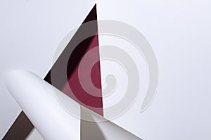 Top view of rolled white paper and dark red paper.Empty space for design photo