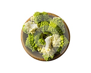 Top view. Roman cauliflower on wooden bowl isolated on white. Roman cauliflower close up. Fractal texture of romanesco broccoli.